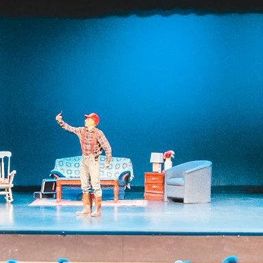 Actor on stage under bright lighting